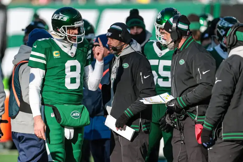 Dec 22, 2024; East Rutherford, New Jersey, USA; New York Jets quarterback Aaron Rodgers (8) talks with head coach Jeff Ulbrich during the first half against the Los Angeles Rams at MetLife Stadium. Mandatory Credit: Vincent Carchietta-Imagn Images Packers