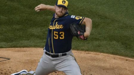 Milwaukee Brewers starting pitcher Brandon Woodruff (53) throws the ball against the Chicago Cubs during the first inning of an opening day baseball game Friday, July, 24, 2020, in Chicago. (AP Photo/David Banks)