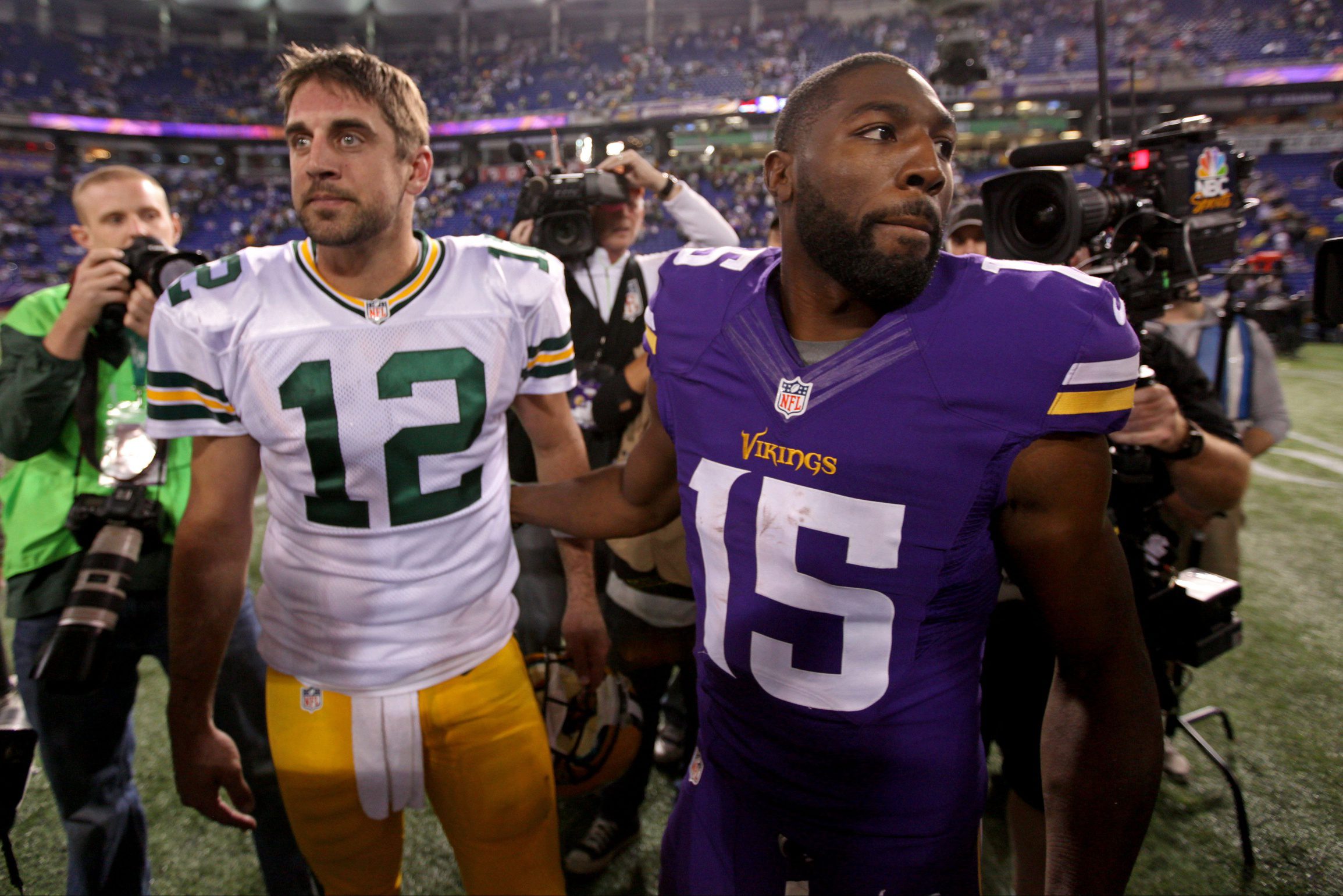 Oct 27, 2013; Minneapolis, MN, USA; Minnesota Vikings wide receiver Greg Jennings (15) talks with Green Bay Packers quarterback Aaron Rodgers (12) following the game at Mall of America Field at H.H.H. Metrodome. The Packers defeated the Vikings 44-31. Mandatory Credit: Brace Hemmelgarn-USA TODAY Sports