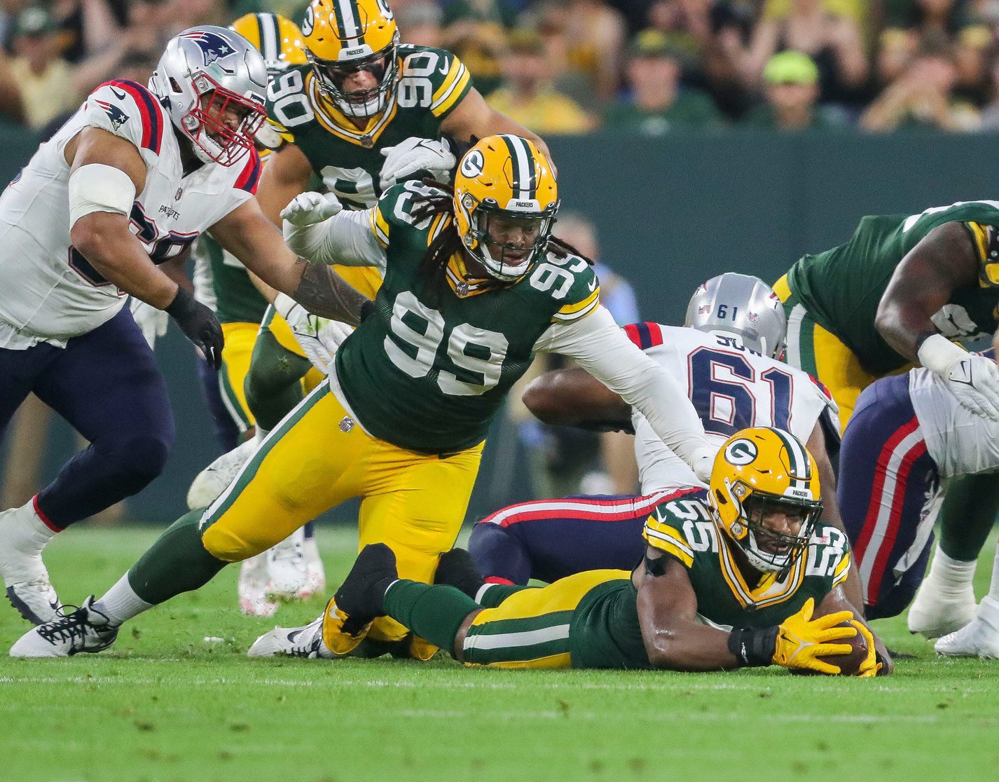 Green Bay Packers linebacker Kingsley Enagbare (55) recovers a fumble against the New England Patriots during their preseason football game Saturday, August 19, 2023, at Lambeau Field in Green Bay, Wis.