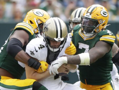 Sep 24, 2023; Green Bay, Wisconsin, USA; Green Bay Packers linebacker Rashan Gary (52) and linebacker Quay Walker (7) sack New Orleans Saints quarterback Derek Carr (4) at Lambeau Field. Mandatory Credit: Wm. Glasheen-USA TODAY Sports