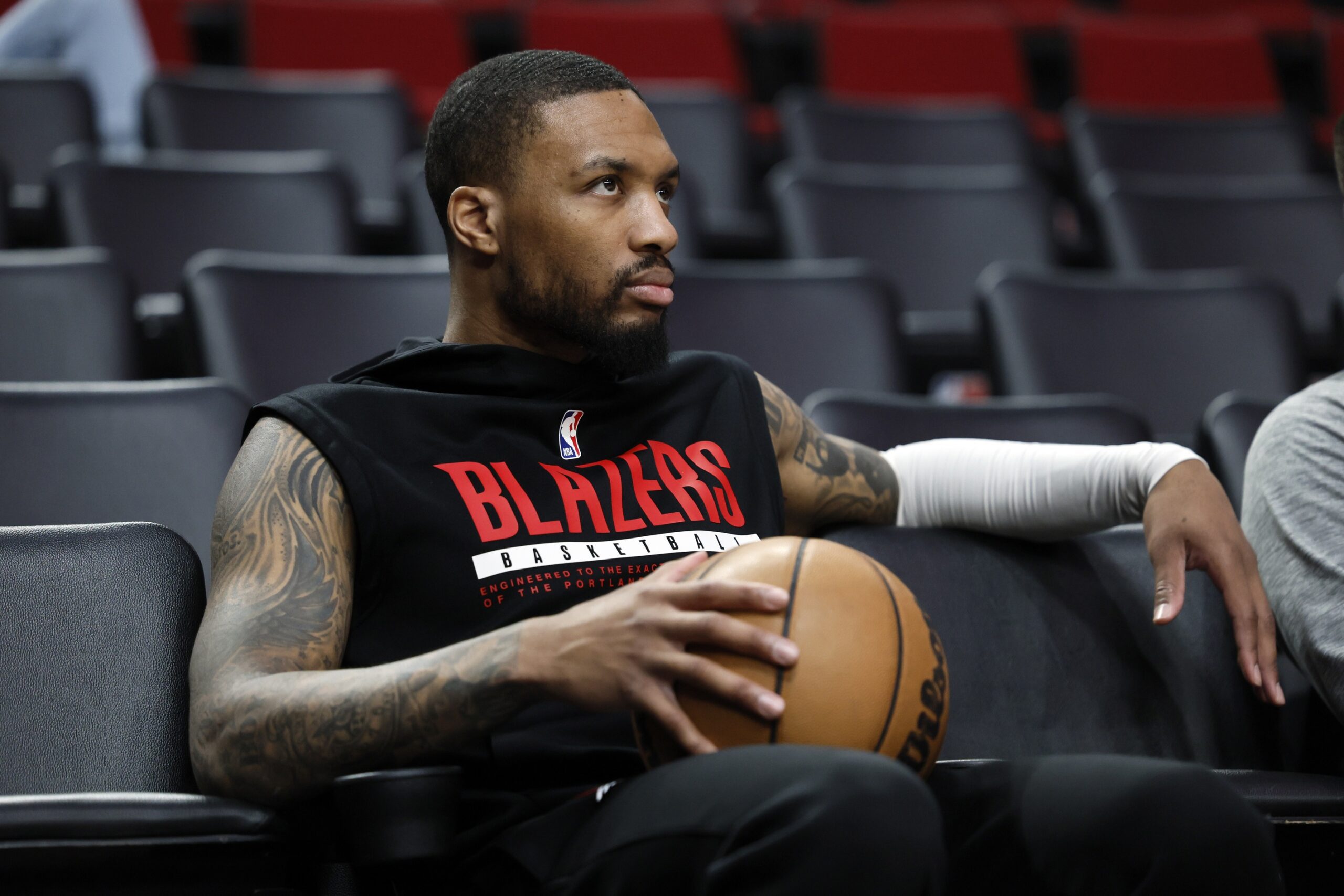 Mar 27, 2023; Portland, Oregon, USA; Portland Trail Blazers point guard Damian Lillard (0) watches players warm up prior to the game against the New Orleans Pelicans at Moda Center. Mandatory Credit: Soobum Im-USA TODAY Sports