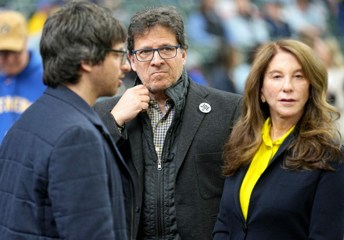 Milwaukee Brewers principal owner Mark Attanasio, center, is is shown before the Milwaukee Brewers home opener against the New York Mets Monday, April 3, 2023 at American Family Field in Milwaukee, Wis.