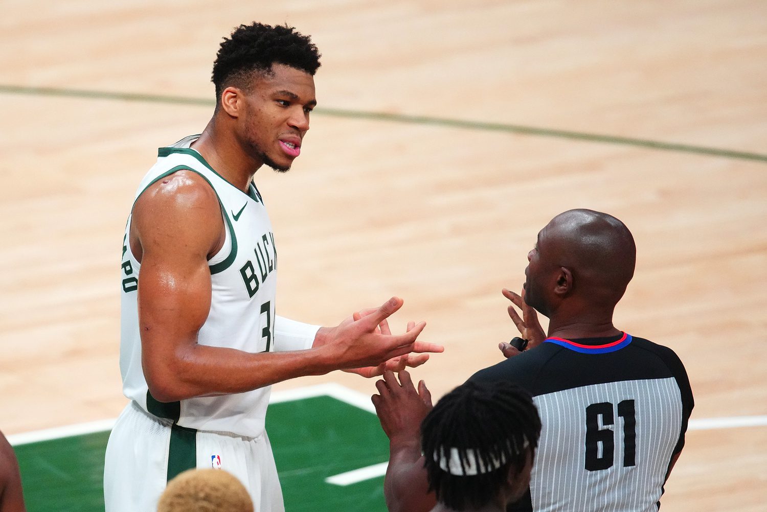 Jul 14, 2021; Milwaukee, Wisconsin, USA; Milwaukee Bucks forward Giannis Antetokounmpo (34) talks with referee Courtney Kirkland (61) during the third quarter against the Phoenix Suns during game four of the 2021 NBA Finals at Fiserv Forum. Mandatory Credit: Mark J. Rebilas-USA TODAY Sports