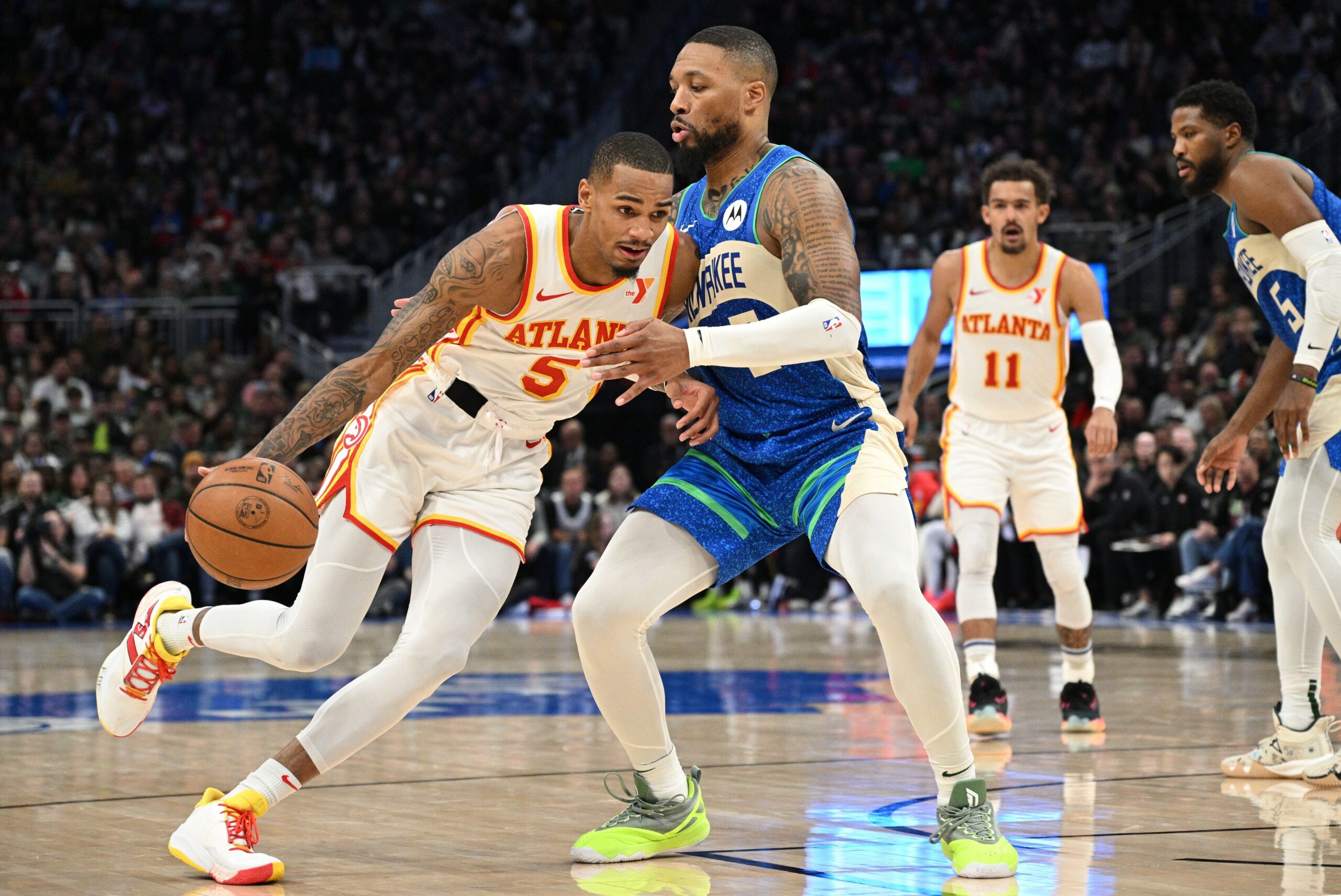 Dec 2, 2023; Milwaukee, Wisconsin, USA; Atlanta Hawks guard Dejounte Murray (5) drives to the basket against Milwaukee Bucks guard Damian Lillard (0) in the second half at Fiserv Forum. Mandatory Credit: Michael McLoone-USA TODAY Sports