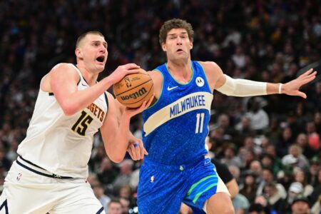 Feb 12, 2024; Milwaukee, Wisconsin, USA; Denver Nuggets center Nikola Jokic (15) drives for the basket against Milwaukee Bucks center Brook Lopez (11) in the third quarter at Fiserv Forum. Mandatory Credit: Benny Sieu-USA TODAY Sports