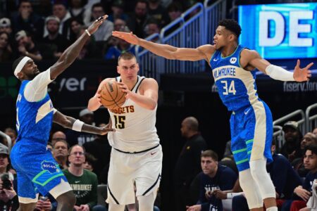 Feb 12, 2024; Milwaukee, Wisconsin, USA; Denver Nuggets center Nikola Jokic (15) is pressured by Milwaukee Bucks forward Bobby Portis (9) and forward Giannis Antetokounmpo (34) in the second quarter at Fiserv Forum. Mandatory Credit: Benny Sieu-USA TODAY Sports