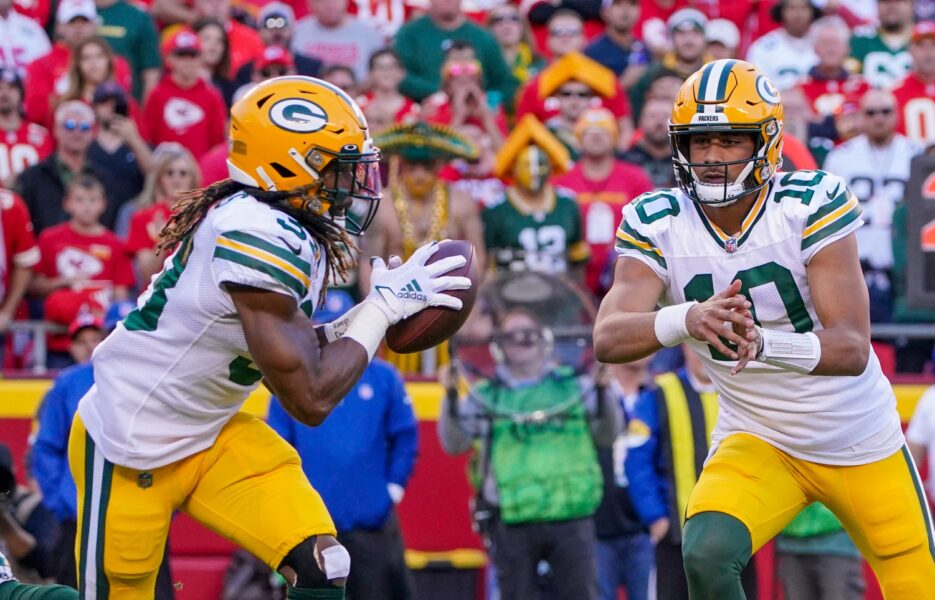 Nov 7, 2021; Kansas City, Missouri, USA; Green Bay Packers quarterback Jordan Love (10) pitches the ball to running back Aaron Jones (33) against the Kansas City Chiefs during the first half at GEHA Field at Arrowhead Stadium. Mandatory Credit: Denny Medley-USA TODAY Sports