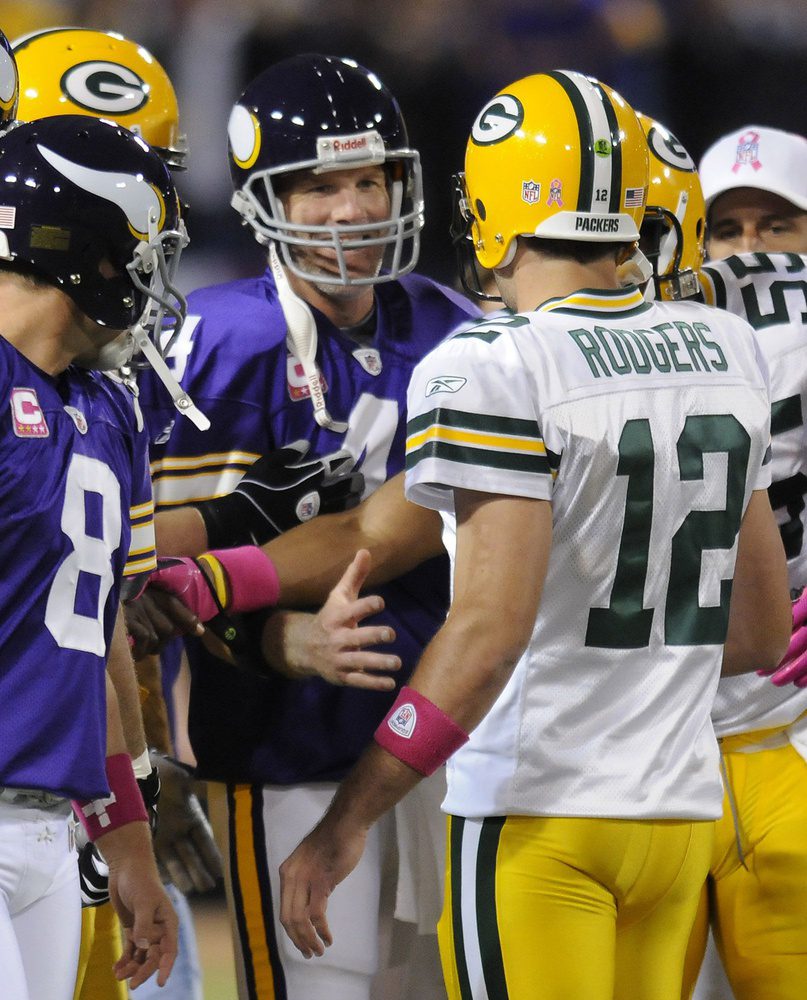 Green Bay Packers quarterback Aaron Rodgers (12) meets with Minnesota Vikings quarterback Brett Favre at midfield on Oct. 5, 2009, at the Metrodome in Minneapolis. Photo by Evan Siegle/Press-Gazette