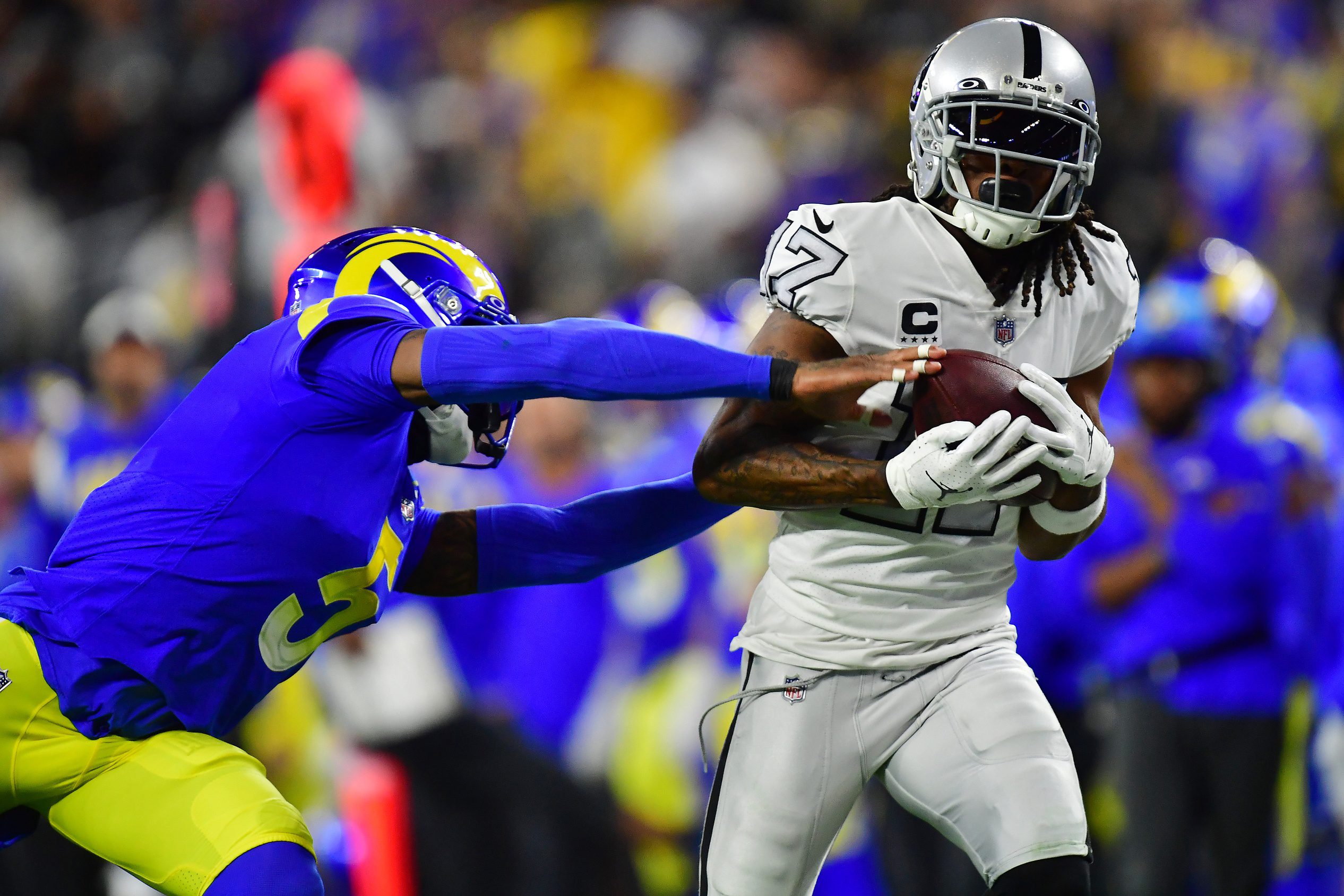 Dec 8, 2022; Inglewood, California, USA; Las Vegas Raiders wide receiver Davante Adams (17) catches a pass against Los Angeles Rams cornerback Jalen Ramsey (5) during the first half at SoFi Stadium. Mandatory Credit: Gary A. Vasquez-USA TODAY Sports