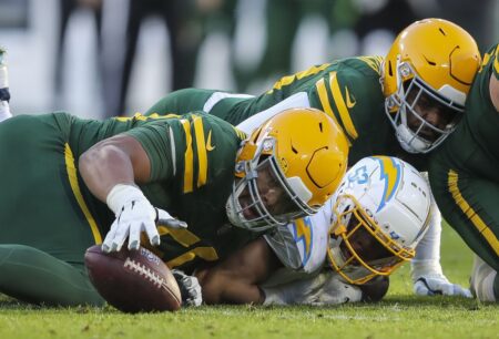 Sunday, November 19, 2023; Green Bay, WI; Green Bay Packers guard Zach Tom (50) recovers a fumble forced by Los Angeles Chargers linebacker Khalil Mack (52) during the game at Lambeau Field. Mandatory Credit: Tork Mason-USA TODAY NETWORK