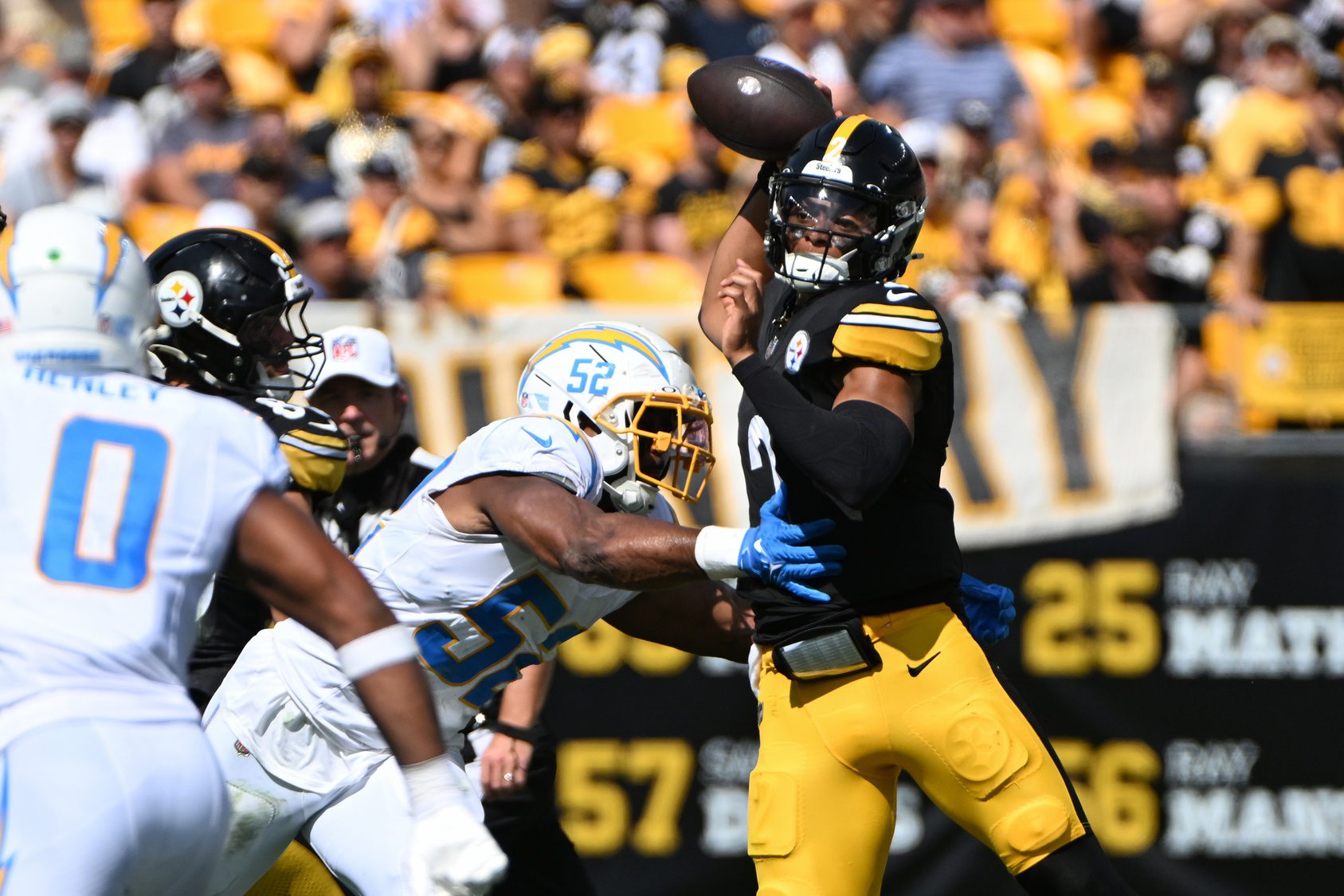 Sep 22, 2024; Pittsburgh, Pennsylvania, USA; Pittsburgh Steelers quarterback Justin Fields (2) throws a pass while under pressure from Los Angeles Chargers linebacker Khalil Mack (52) during the second quarter at Acrisure Stadium. Mandatory Credit: Barry Reeger-Imagn Images Packers