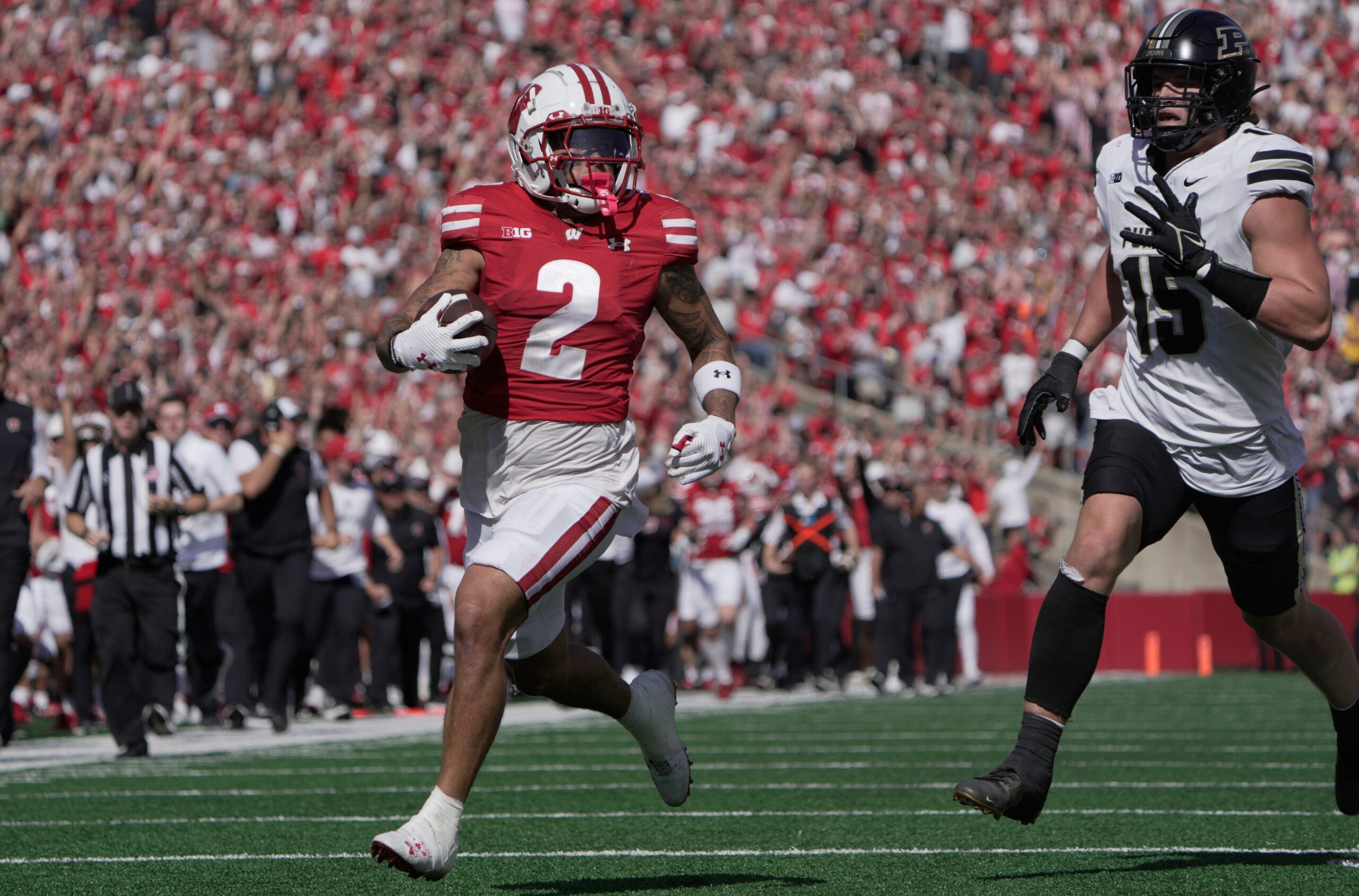 Wisconsin wide receiver Trech Kekahuna (2) scores a touchdown on a 69-yard reception as Purdue defensive back Botros Alisandro (19) looks on during the third quarter of their game Saturday, October 5, 2024 at Camp Randall Stadium in Madison, Wisconsin.