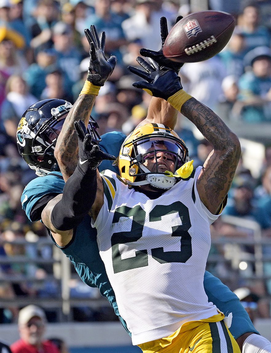 Oct 27, 2024; Jacksonville, Florida, USA; Green Bay Packers defensive back Jaire Alexander (23) defends a pass intended for Jacksonville Jaguars wide receiver Parker Washington (11) during the fourth quarter at EverBank Stadium. Mandatory Credit: Melina Myers