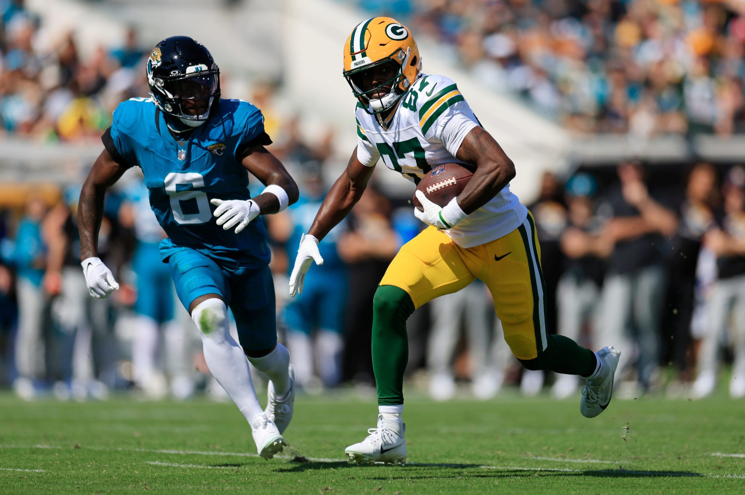 Green Bay Packers wide receiver Romeo Doubs (87) rushes for yards against Jacksonville Jaguars safety Darnell Savage (6) during the first quarter of an NFL football matchup Sunday, Oct. 27, 2024 at EverBank Stadium in Jacksonville, Fla. The Packers edged the Jaguars 30-27 on a last-second field goal. [Corey Perrine/Florida Times-Union]