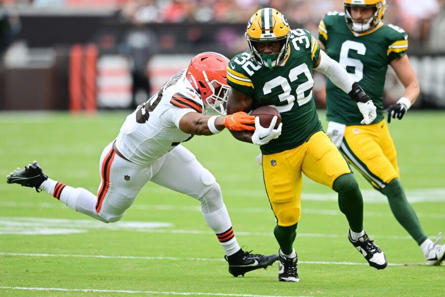 Aug 10, 2024; Cleveland, Ohio, USA; Green Bay Packers running back MarShawn Lloyd (32) runs with the ball as Cleveland Browns linebacker Caleb Johnson (48) defends during the second half at Cleveland Browns Stadium. Mandatory Credit: Ken Blaze-USA TODAY Sports