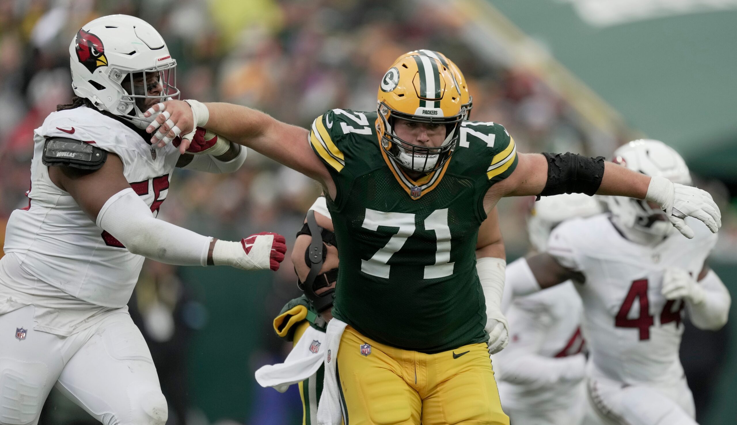 Green Bay Packers center Josh Myers (71) blocks Arizona Cardinals defensive tackle Dante Stills (55) during the quarter of their game Sunday, October 13, 2024 at Lambeau Field in Green Bay, Wisconsin. The Green Bay Packers beat the Arizona Cardinals 34-13.