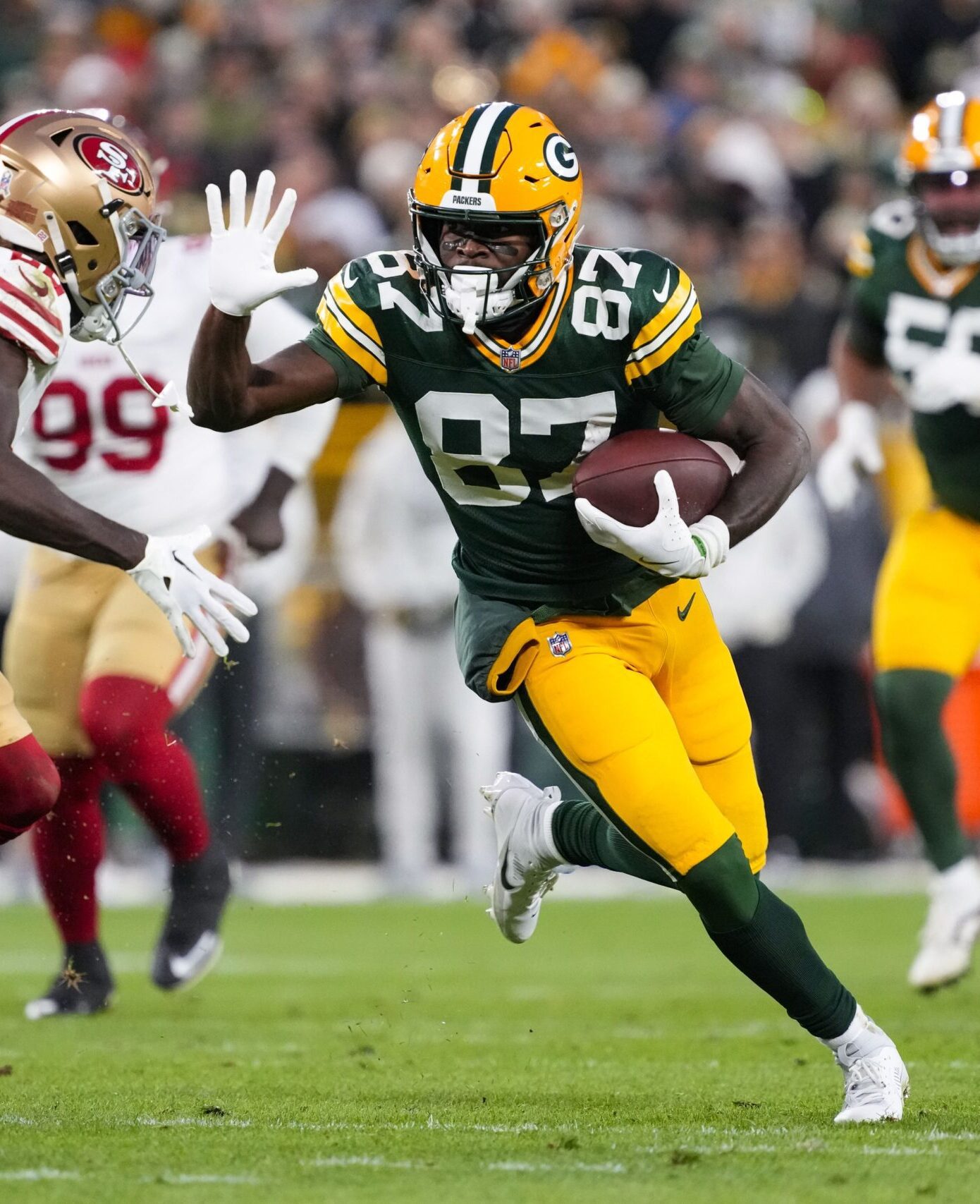 Nov 24, 2024; Green Bay, Wisconsin, USA;  Green Bay Packers wide receiver Romeo Doubs (87) rushes with the football after catching a pass during the second quarter against the San Francisco 49ers at Lambeau Field. Mandatory Credit: Jeff Hanisch-Imagn Images
