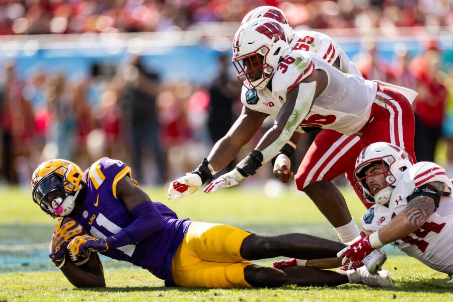 Wisconsin Badgers linebacker Jake Chaney (36) and Wisconsin Badgers safety Preston Zachman (14) and LSU Tigers wide receiver Brian Thomas Jr. (11)