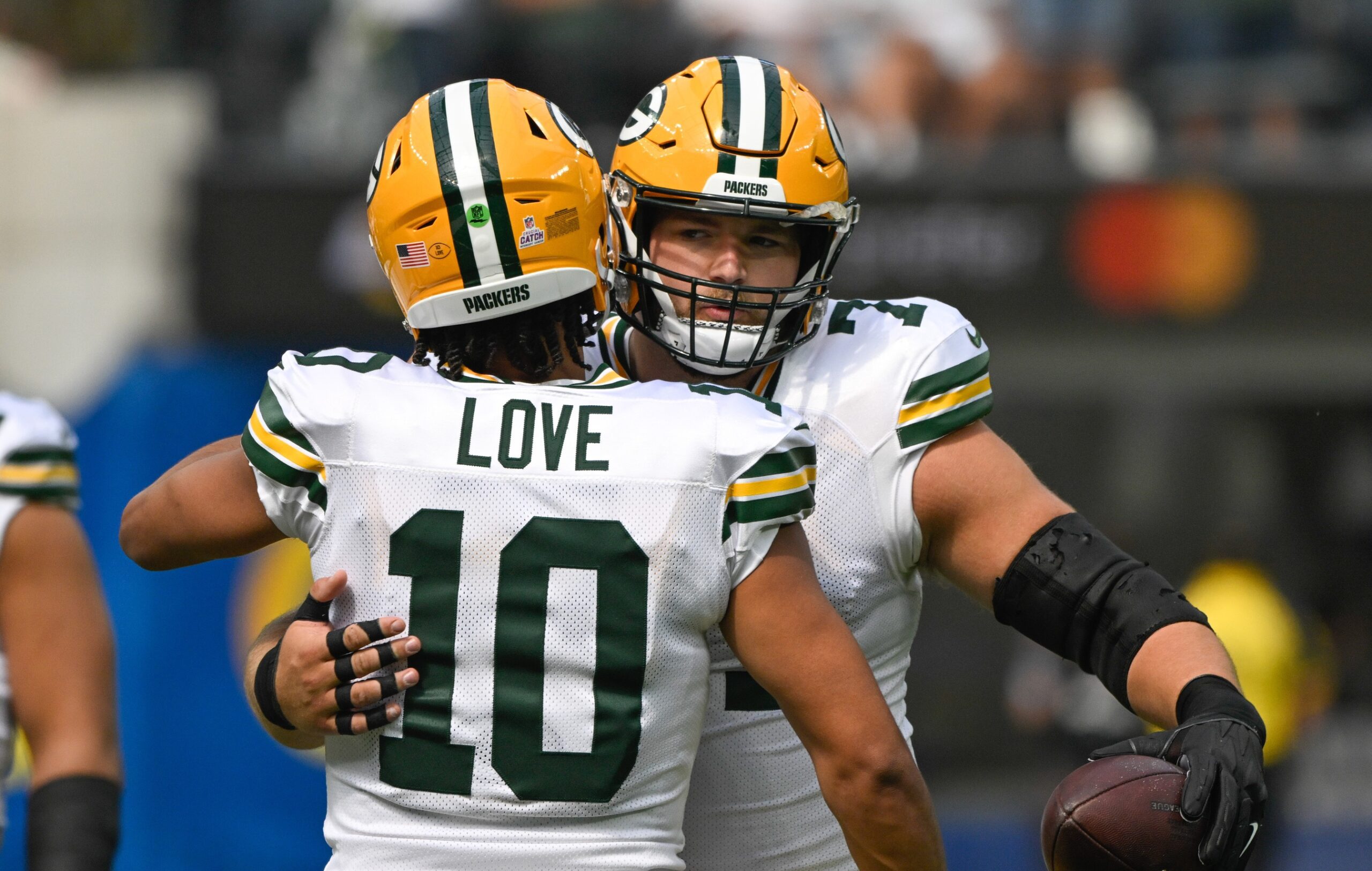 Oct 6, 2024; Inglewood, California, USA; Green Bay Packers quarterback Jordan Love (10) hugs center Josh Myers (71) before an NFL game against the Los Angeles Rams at SoFi Stadium. Mandatory Credit: Robert Hanashiro-Imagn Images