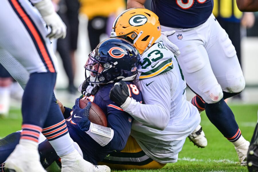 Nov 17, 2024; Chicago, Illinois, USA; Chicago Bears quarterback Caleb Williams (18) is sacked by Green Bay Packers defensive tackle Tedarrell Slaton (93) the during fourth quarter at Soldier Field. Mandatory Credit: Daniel Bartel-Imagn Images