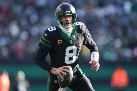 Dec 1, 2024; East Rutherford, New Jersey, USA; New York Jets quarterback Aaron Rodgers (8) scrambles during the first quarter against the New York Jets at MetLife Stadium. Mandatory Credit: Vincent Carchietta-Imagn Images