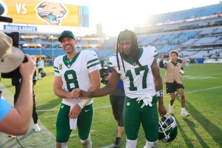 New York Jets quarterback Aaron Rodgers (8) and wide receiver Davante Adams (17) high-five each other as they walks off the field after the game Sunday, Dec. 15, 2024 at EverBank Stadium in Jacksonville, Fla. The Jets held off the Jaguars 32-25. [Corey Perrine/Florida Times-Union]