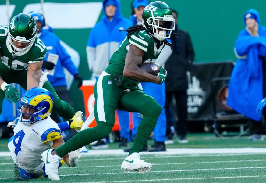 New York Jets wide receiver Allen Lazard (10) takes care of Los Angeles Rams cornerback Ahkello Witherspoon (4) as New York Jets wide receiver Davante Adams (17) continues with the ball after completing a pass for a first down in the second quarter, Sunday, December 22, 2024, in East Rutherford.