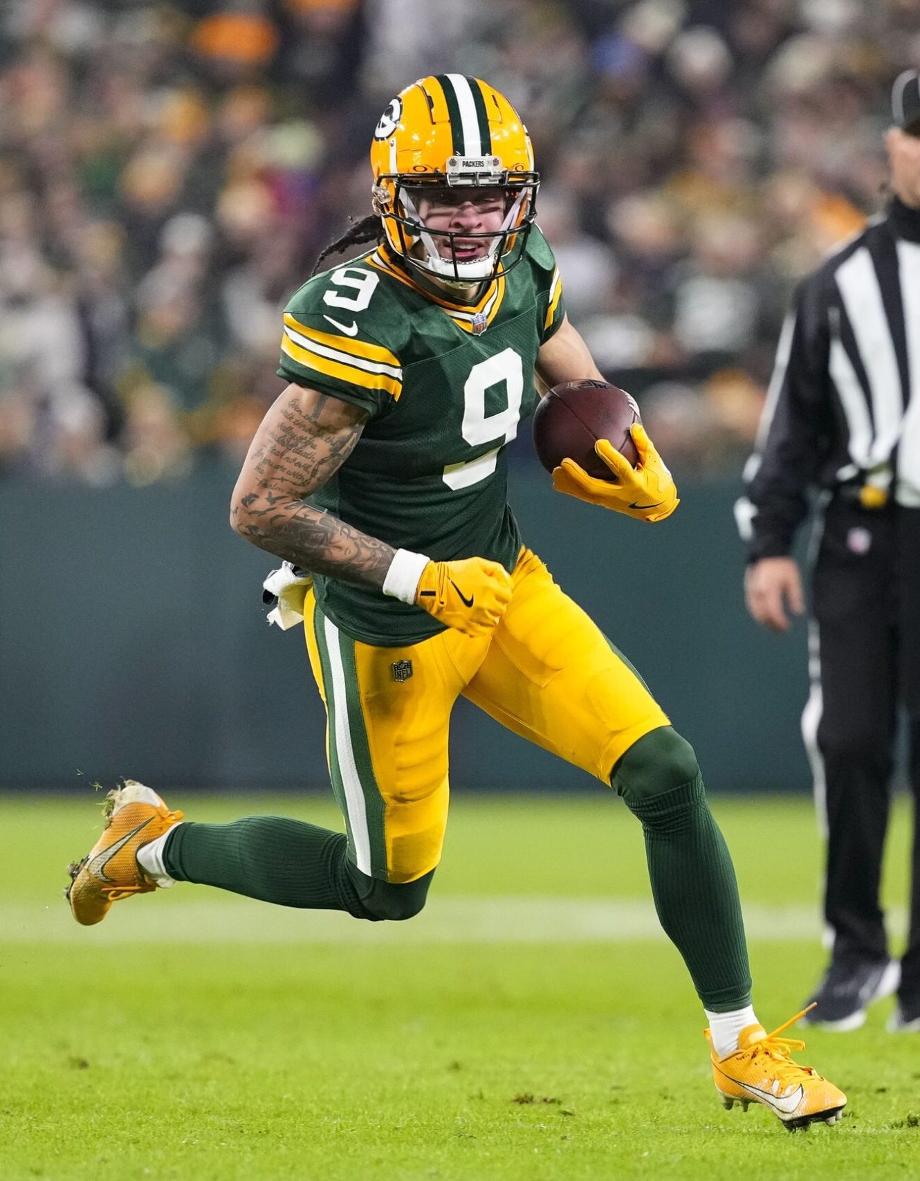 Dec 23, 2024; Green Bay, Wisconsin, USA; Green Bay Packers wide receiver Christian Watson (9) rushes with the football during the second quarter against the New Orleans Saints at Lambeau Field. Mandatory Credit: Jeff Hanisch-Imagn Images