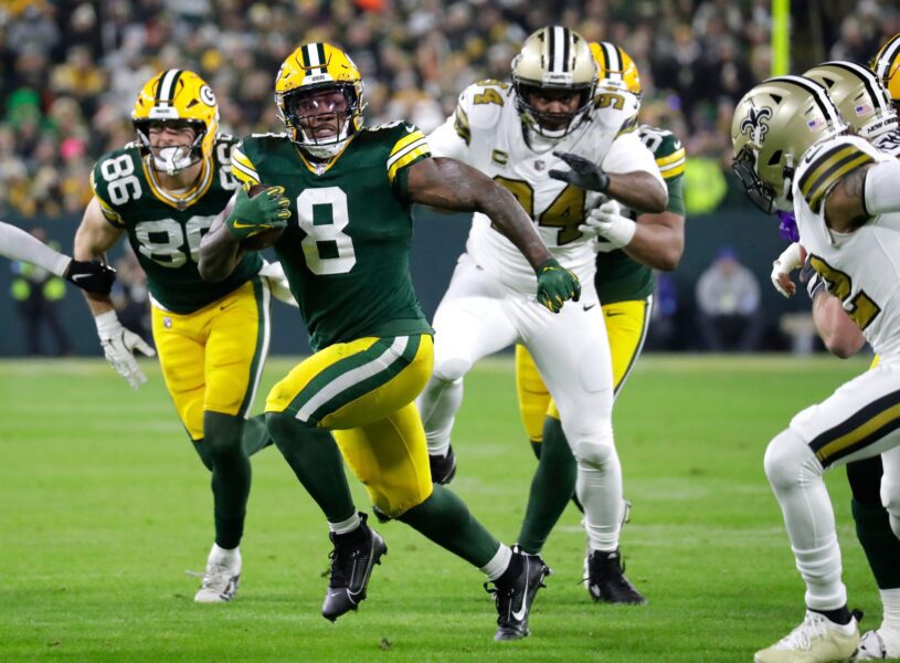 Green Bay Packers running back Josh Jacobs (8) runs for a first down against the New Orleans Saints during their football game Monday, December 23, 2024, at Lambeau Field in Green Bay, Wisconsin.