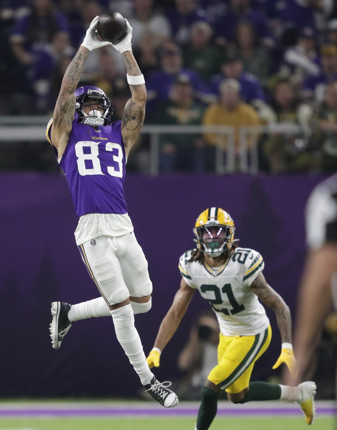 Dec 29, 2024; Minneapolis, Minnesota, USA; Minnesota Vikings wide receiver Jalen Nailor (83) pulls down a first down reception against Green Bay Packers cornerback Eric Stokes (21) in the third quarter at U.S. Bank Stadium. Mandatory Credit: Dan Powers/USA TODAY NETWORK-Wisconsin via Imagn Images