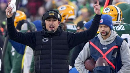 Jan 1, 2023; Green Bay, Wisconsin, USA; Green Bay Packers head coach Matt LaFleur encourages the fans to make noise during the first quarter of their game against the Minnesota Vikings at Lambeau Field. Mandatory Credit: Mark Hoffman-Imagn Images