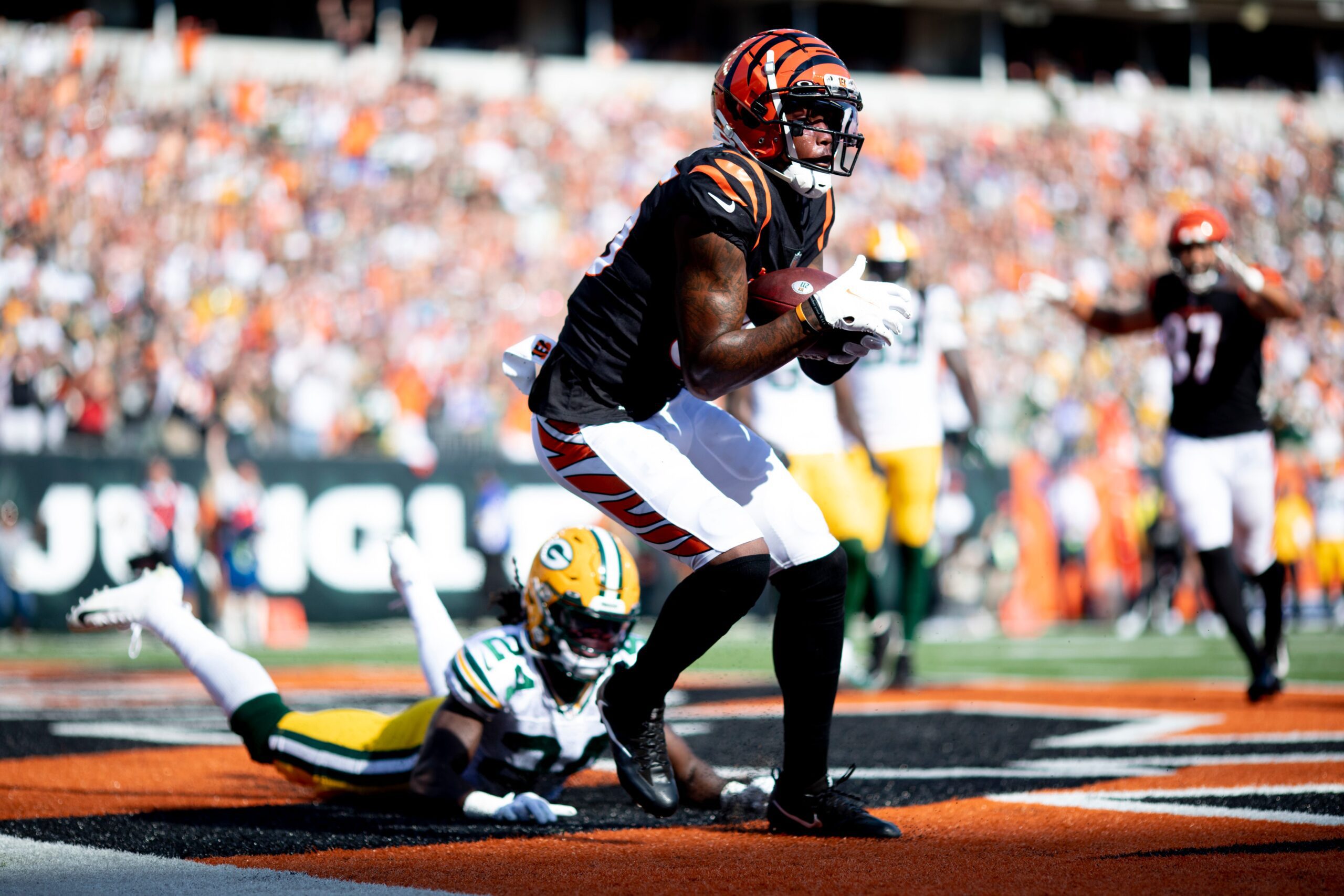 Cincinnati Bengals wide receiver Tee Higgins (85) catches a two point conversion as Green Bay Packers cornerback Isaac Yiadom (24) had attempted to stop him to tie the NFL football game between the Cincinnati Bengals and the Green Bay Packers 22-22 in the fourth quarter on Sunday, Oct. 10, 2021, at Paul Brown Stadium in Cincinnati.