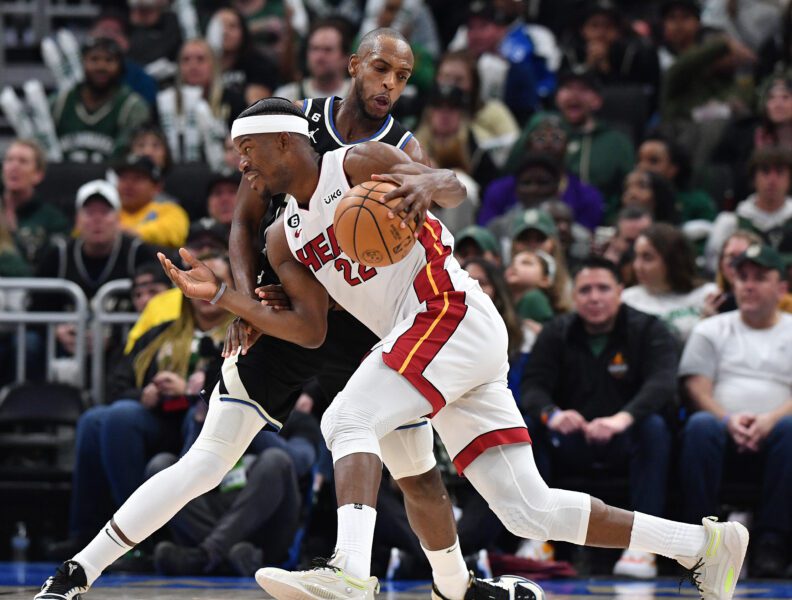 Apr 16, 2023; Milwaukee, Wisconsin, USA; Miami Heat forward Jimmy Butler (22) drives against Milwaukee Bucks forward Khris Middleton (22) in the second half during game one of the 2023 NBA Playoffs at Fiserv Forum. Mandatory Credit: Michael McLoone-USA TODAY Sports