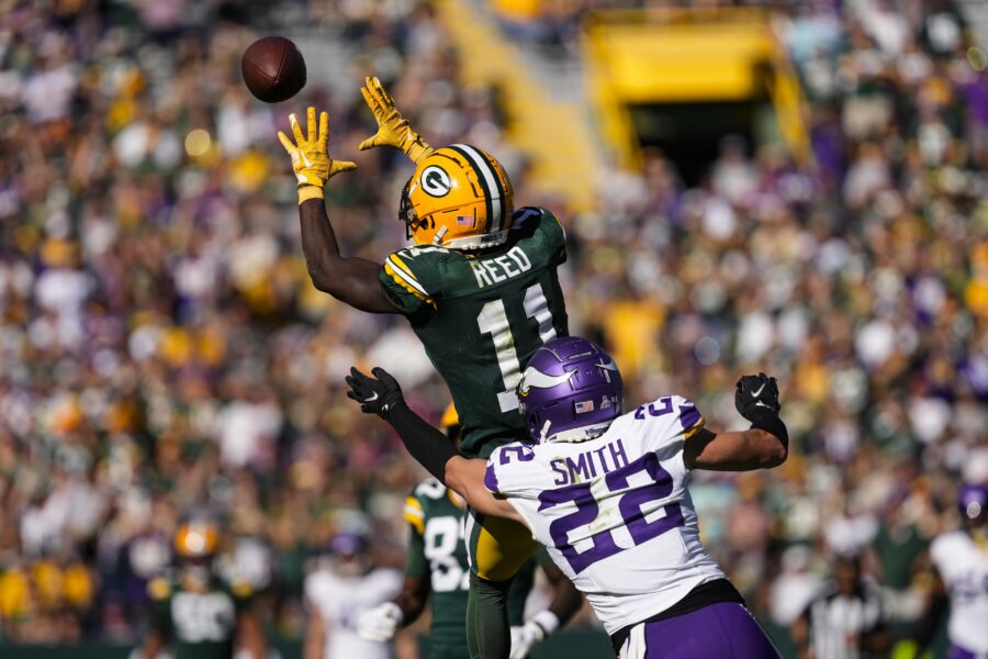 Sep 29, 2024; Green Bay, Wisconsin, USA; Green Bay Packers wide receiver Jayden Reed (11) reaches for a pass in front of Minnesota Vikings safety Harrison Smith (22) during the fourth quarter at Lambeau Field. Mandatory Credit: Jeff Hanisch-Imagn Images