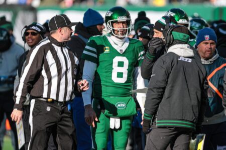 Dec 22, 2024; East Rutherford, New Jersey, USA; New York Jets quarterback Aaron Rodgers (8) talks with head coach Jeff Ulbrich during the first half against the Los Angeles Rams at MetLife Stadium. Mandatory Credit: Vincent Carchietta-Imagn Images