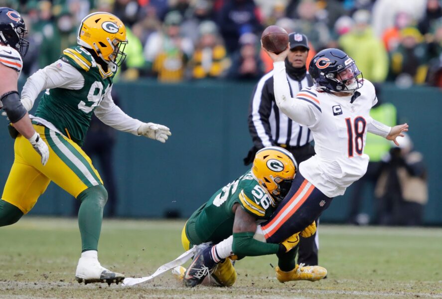 Chicago Bears quarterback Caleb Williams (18) throws an incomplete pass as he is tackled by Green Bay Packers linebacker Edgerrin Cooper (56)