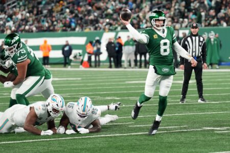 New York Jets quarterback Aaron Rodgers (8) throws his 500th career touchdown pass in the second quarter of the game against the Miami Dolphins on Jan. 5, 2025, in East Rutherford, N.J.