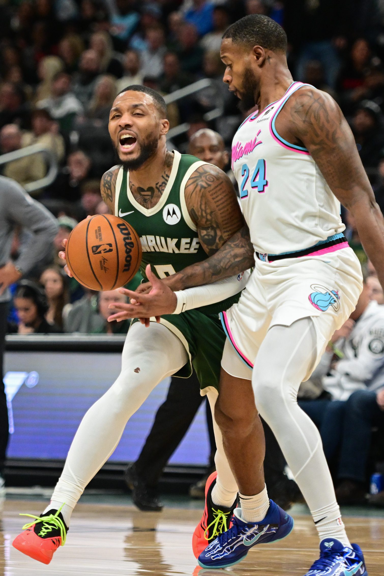 Jan 23, 2025; Milwaukee, Wisconsin, USA; Milwaukee Bucks guard Damian Lillard (0) drives for the basket against Miami Heat forward Haywood Highsmith (24) in the second quarter at Fiserv Forum. Mandatory Credit: Benny Sieu-Imagn Images