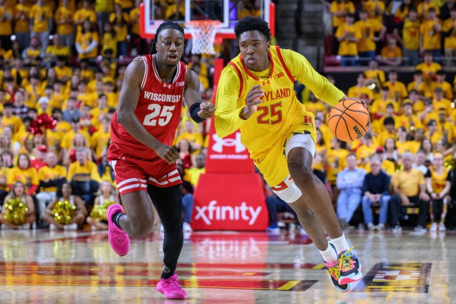 Maryland Terrapins center Derik Queen (25) drives to the basket against Wisconsin basketball guard John Blackwell (25)