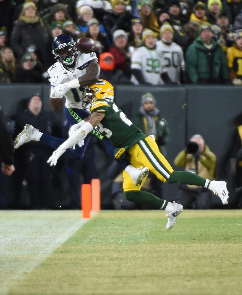 Jan 12, 2020; Green Bay, WI, USA; Green Bay Packers cornerback Jaire Alexander (23) breaks up a pass intended for Seattle Seahawks wide receiver D.K. Metcalf (14) in the first quarter of a NFC Divisional Round playoff football game at Lambeau Field. Mandatory Credit: Benny Sieu-USA TODAY Sports