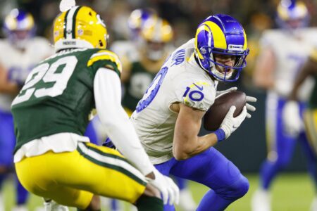 Nov 28, 2021; Green Bay, Wisconsin, USA; Los Angeles Rams wide receiver Cooper Kupp (10) rushes with the football after catching a pass as Green Bay Packers cornerback Rasul Douglas (29) defends during the second quarter at Lambeau Field. Mandatory Credit: Jeff Hanisch-Imagn Images