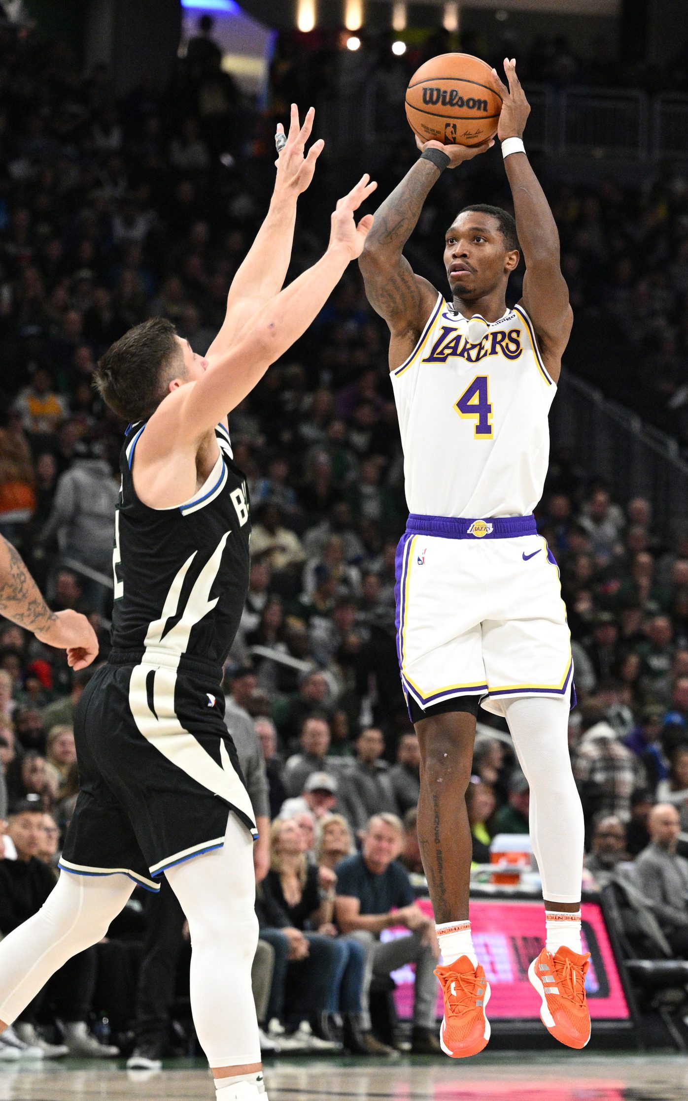 Dec 2, 2022; Milwaukee, Wisconsin, USA; Los Angeles Lakers guard Lonnie Walker IV (4) puts up a shot against Milwaukee Bucks guard Grayson Allen (12) in the second half at Fiserv Forum. Mandatory Credit: Michael McLoone-Imagn Images