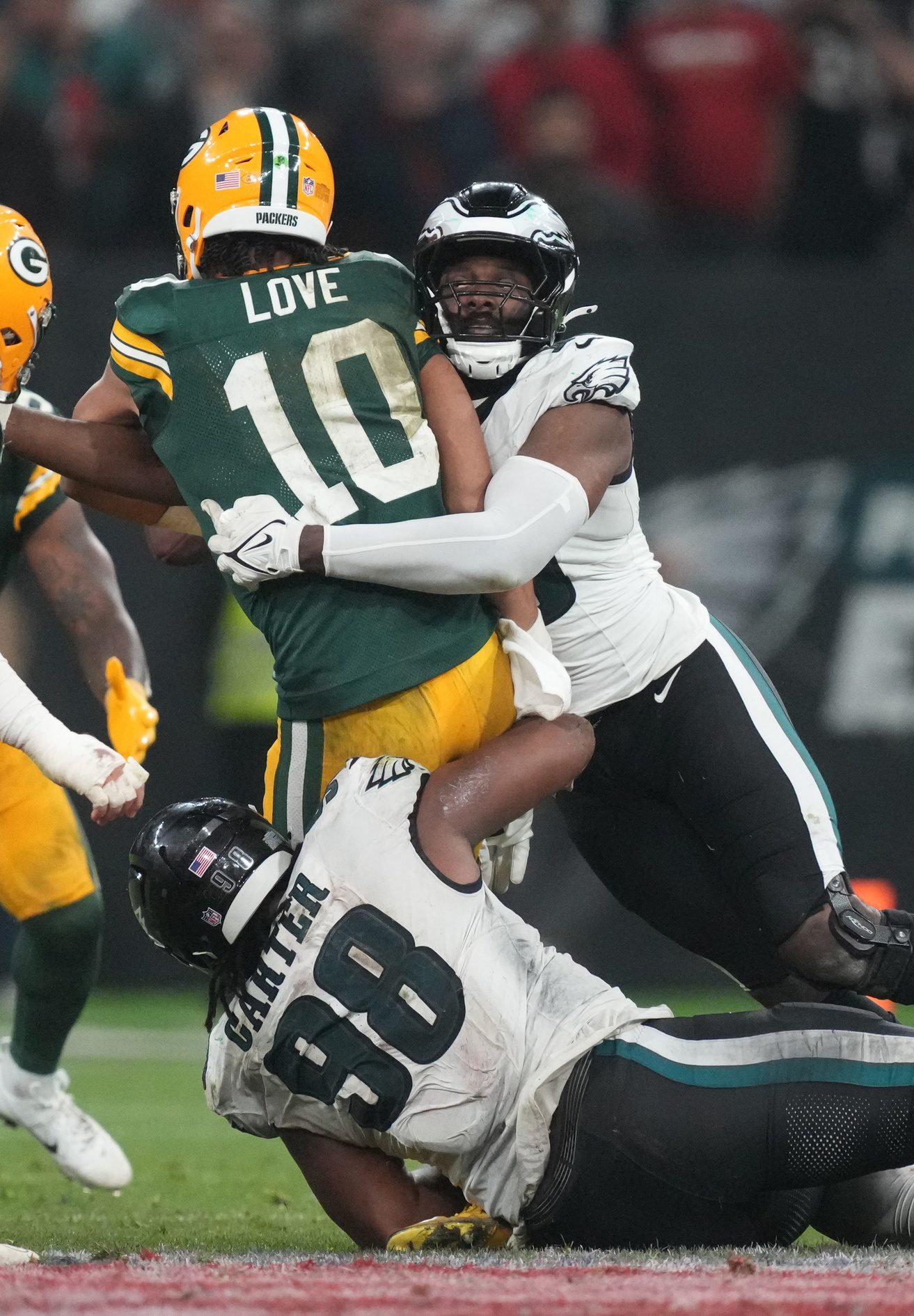 Sep 6, 2024; Sao Paulo, BRA; Green Bay Packers quarterback Jordan Love (10) is pressured by Philadelphia Eagles defensive tackle Jalen Carter (98) and linebacker Josh Sweat (19) during the second half at Neo Quimica Arena. Mandatory Credit: Kirby Lee-Imagn Images