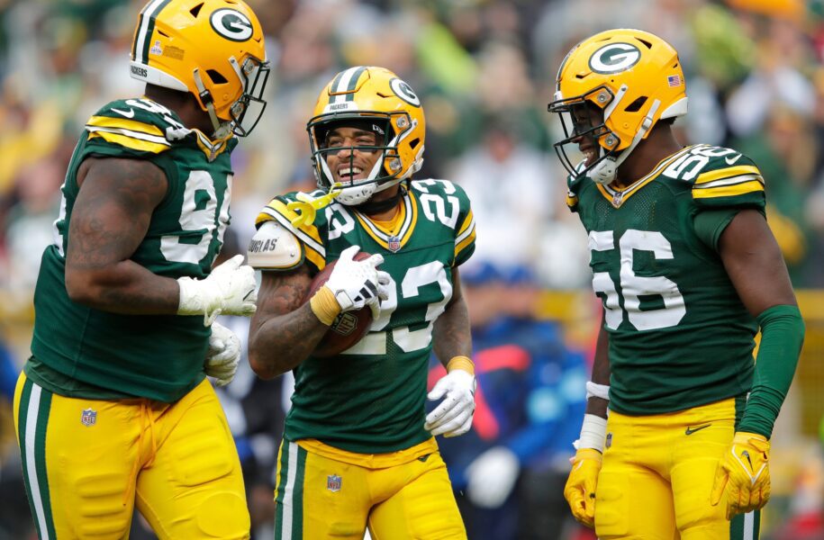 Green Bay Packers cornerback Jaire Alexander (23) celebrates recovering a fumble with teammates