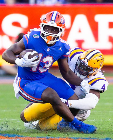 Florida Gators running back Jadan Baugh (13) is tackled by LSU Tigers defensive end Bradyn Swinson (4) during the first half at Ben Hill Griffin Stadium in Gainesville, FL on Saturday, November 16, 2024. [Doug Engle/Gainesville Sun]Packers