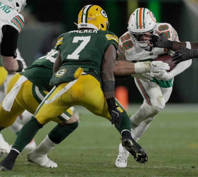 Green Bay Packers linebacker Quay Walker (7) tackles Miami Dolphins running back De’Von Achane (28) during the fourth quarter of their game Thursday, November 28, 2024 at Lambeau Field in Green Bay, Wisconsin.