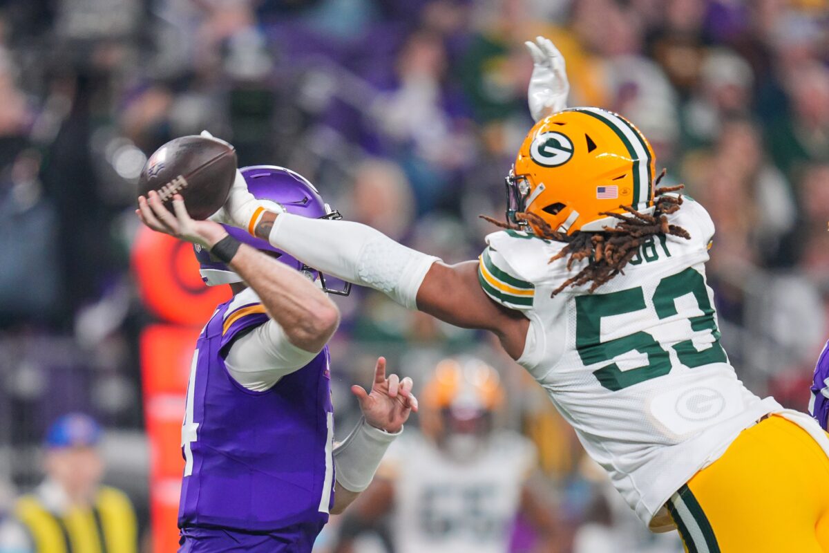 Dec 29, 2024; Minneapolis, Minnesota, USA; Green Bay Packers defensive end Arron Mosby (53) tips the pass against Minnesota Vikings quarterback Sam Darnold (14) in the fourth quarter at U.S. Bank Stadium. Mandatory Credit: Brad Rempel-Imagn Images