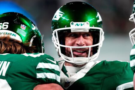 New York Jets quarterback Aaron Rodgers (8) smiles after throwing his fourth touchdown pass of the day, Sunday January 5, 2025, in East Rutherford.