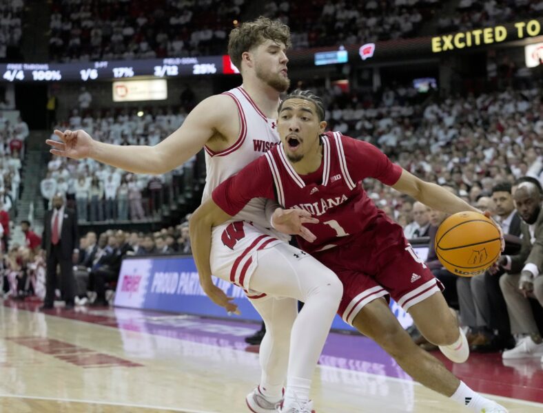 The Guardian of Indiana Myles Rice (1) is fouled by Wisconsin Guard Max Klesmit (11)